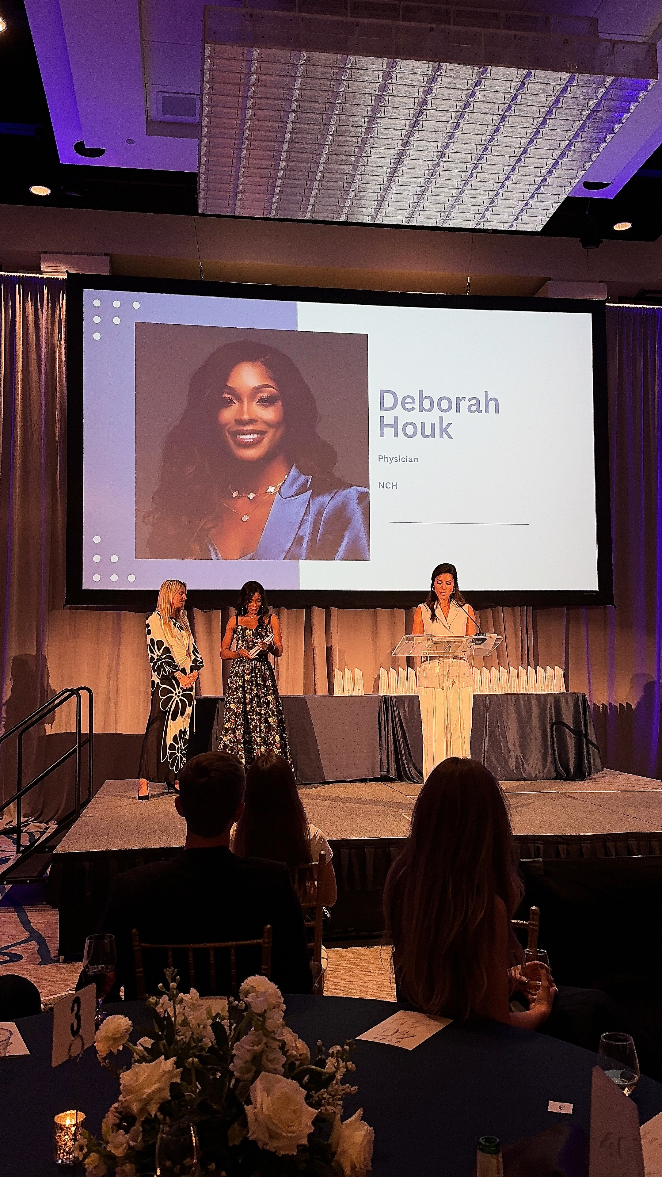 Dr. Deborah Houk recognized on stage at the Gulfshore Business 40 Under 40 ceremony